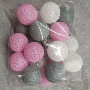 Pink white and grey cotton ball string lights in clear packaging for holiday decor