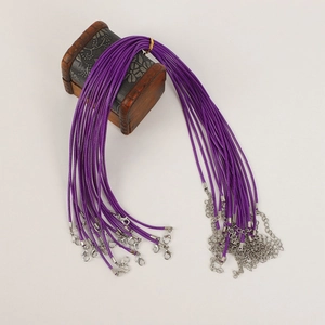 Purple necklace cord detail with silver lobster clasp and extension chain on wood