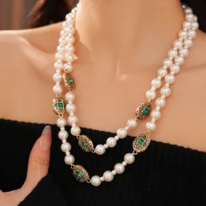 Vintage double layer pearl necklace with emerald green stone and gold accents