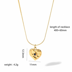 Detail of 18k gold heart pendant with blue stone and product dimension measurements