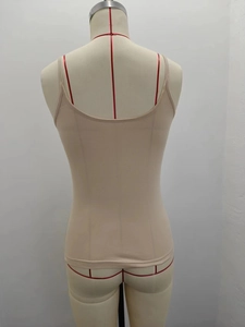 Close-up of beige camisole showing slim fit design and U-shaped back on dress form