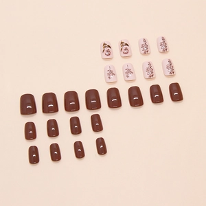 Short minimalist mocha brown and floral fake nails with small pearl accents and glossy finish