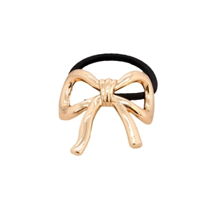 Elastic hair tie with a polished golden metal bow charm on a clean white background