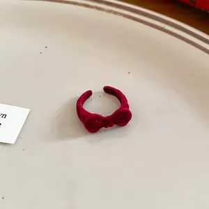 Elegant red flocked velvet bow ring with adjustable open band for a vintage style