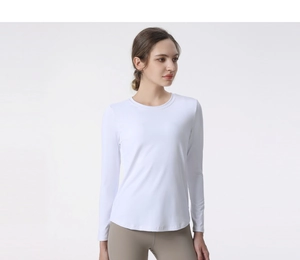 Detail of slim fit long sleeve yoga shirt showing breathable fabric and curved hemline