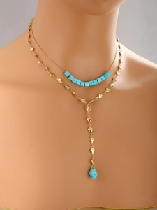 Detail of 14K gold plated double layer Y-necklace with turquoise beads on model