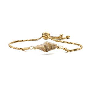 Detail showing shell charm on golden stainless steel box chain bracelet with slide clasp