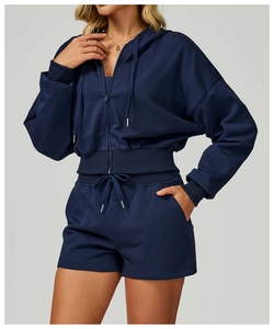 Detail view of navy blue hooded zip-up sweatshirt with ribbed cuffs and matching shorts