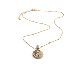 Golden Yin Yang pendant necklace with sparkling cubic zirconia on a delicate fine chain