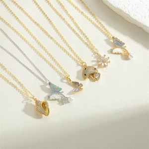 Elegant gold and silver nature pendants with pearls and zircon on a textured stone