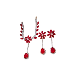 Vintage zircon flower and teardrop jewelry set with red gemstones on white background