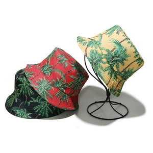 Tre cappelli alla pescatora con stampe di palme tropicali in nero, rosso e beige per l'estate