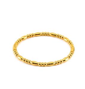 Detailed view of polished gold beaded bracelet with alternating olive and round bead shapes
