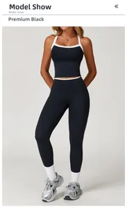 Detail van zwarte yoga-set met hoge stretch en witte contrastbiezen in de taille en nek