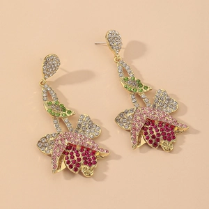 Detail of vintage tulip drop earrings with pink rhinestones and gold floral setting
