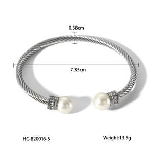 Detail view of twisted stainless steel cable bracelet with pearl and crystal ends showing sizes