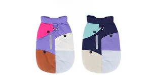 Detail of color-block dog vests featuring D-ring attachment and reflective safety strips