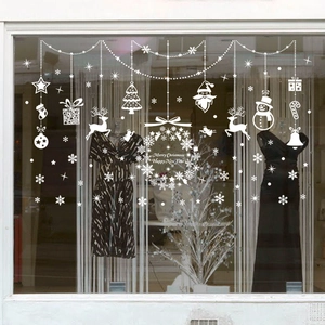 White Christmas window decals with Santa, reindeer and snowflakes on a glass storefront