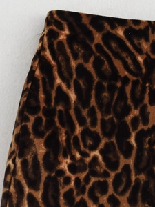 Macro shot of brown leopard print fabric texture and velvet finish on a mini skirt