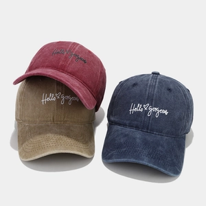 Three washed cotton baseball caps in burgundy, khaki, and navy with Hello Gorgeous embroidery