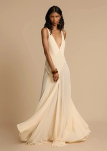 Detail of elegant lace embroidery and deep V-neck on a beige sleeveless maxi dress