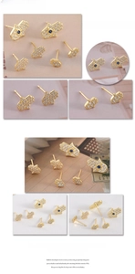 Detailed macro view of gold Hamsa Hand stud earrings with white zircons and blue stone