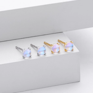 Close-up of S925 sterling silver stud earrings with iridescent round moonstones