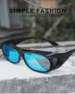 Outdoor close-up of blue mirror lens sport sunglasses with black frame on stone surface
