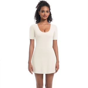 Detail of the deep U-neckline and form-fitting bodice on the cream white sports dress