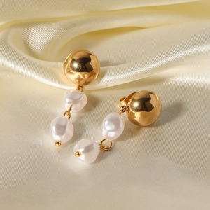 Elegant gold spherical stud earrings with double baroque pearl tassels on silk fabric