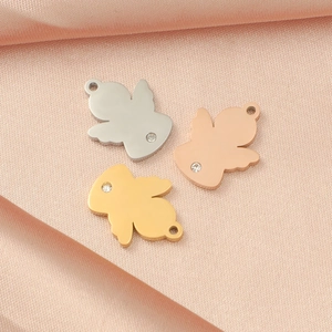 Three mirror-polished titanium steel angel charms with crystals in gold, silver and rose gold