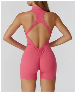 Detail of high-stretch rose pink yoga bodysuit featuring a backless cross-strap design