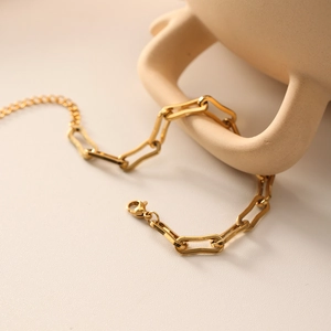 Adjustable 18k gold plated stainless steel paperclip chain bracelet on ceramic decor