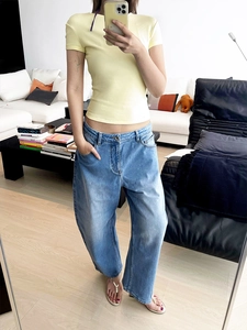 Slim fit light yellow short sleeve T-shirt paired with light blue wide leg jeans