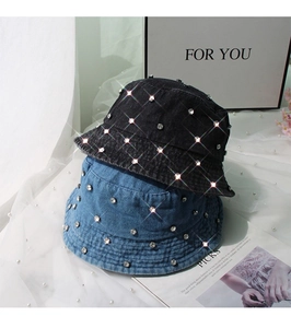 Detail of washed denim bucket hats with rhinestone studs in black and light blue