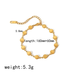 Macro shot of 18k gold stainless steel bracelet with round charms and adjustable chain