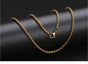 Close-up of a polished gold stainless steel round link chain with a secure lobster clasp