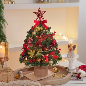 Miniature Christmas tree with LED lights, pine cones, and red ornaments on wood base