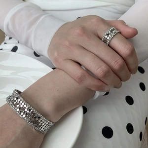 Elegant multi-layered silver metal jewelry set featuring a zircon bracelet and matching ring