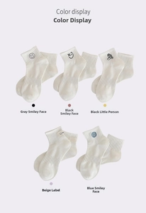 Close-up of five white cotton socks featuring various cute cartoon embroidered icons