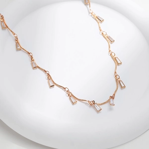 Detail of rose gold wavy necklace chain with rectangular cubic zirconia charms