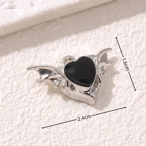 Macro detail of gothic bat wing heart pendant in silver and black with size dimensions