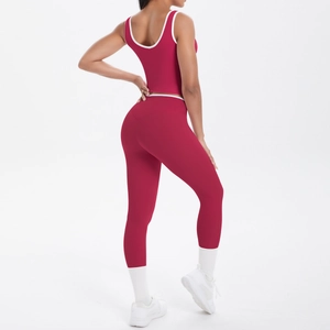 Detail of high-waist yoga pants and racerback top with white trim in dark red