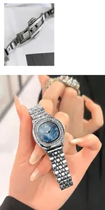 Detail of silver five-link metal strap and double-push butterfly clasp on luxury watch