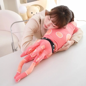 Pink cartoon plush octopus pillow used as a headrest in a cozy home setting