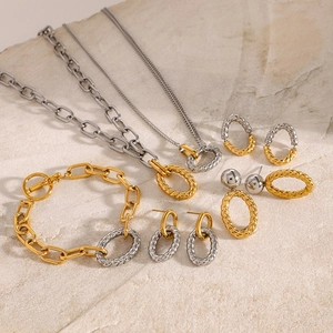 Detailed flat lay of two-tone gold and silver chain jewelry set with twisted textures