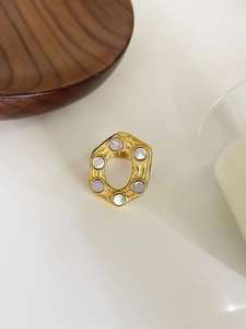 Macro detail of hexagonal 18K gold plated stainless steel ring with white shell inlay
