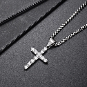 Macro shot of silver hip hop cross pendant with pave-set sparkling zircon stones