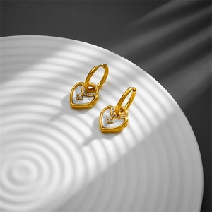 Punk luxury heart-shaped earrings in gold with white shell inlay and zircon accents