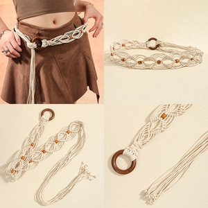Detail of woven bohemian belt with wooden ring buckle, beads and fringe tassels in cream cotton